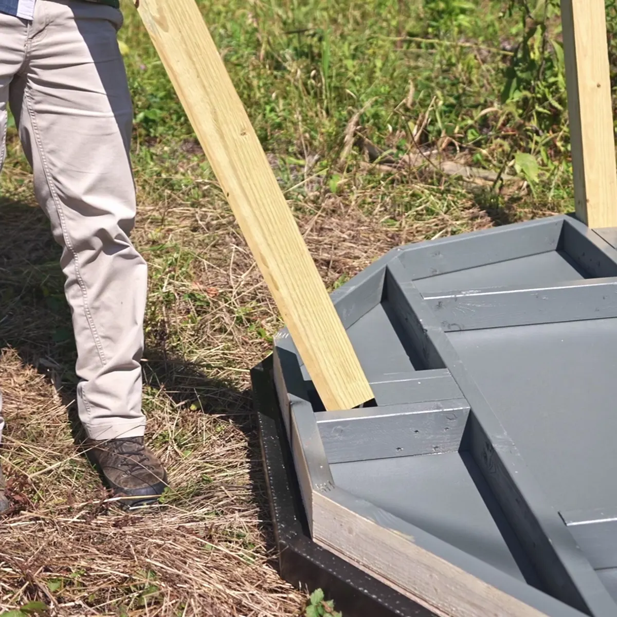 A tower leg dropping into a pre-cut post pocket in the floor frame.