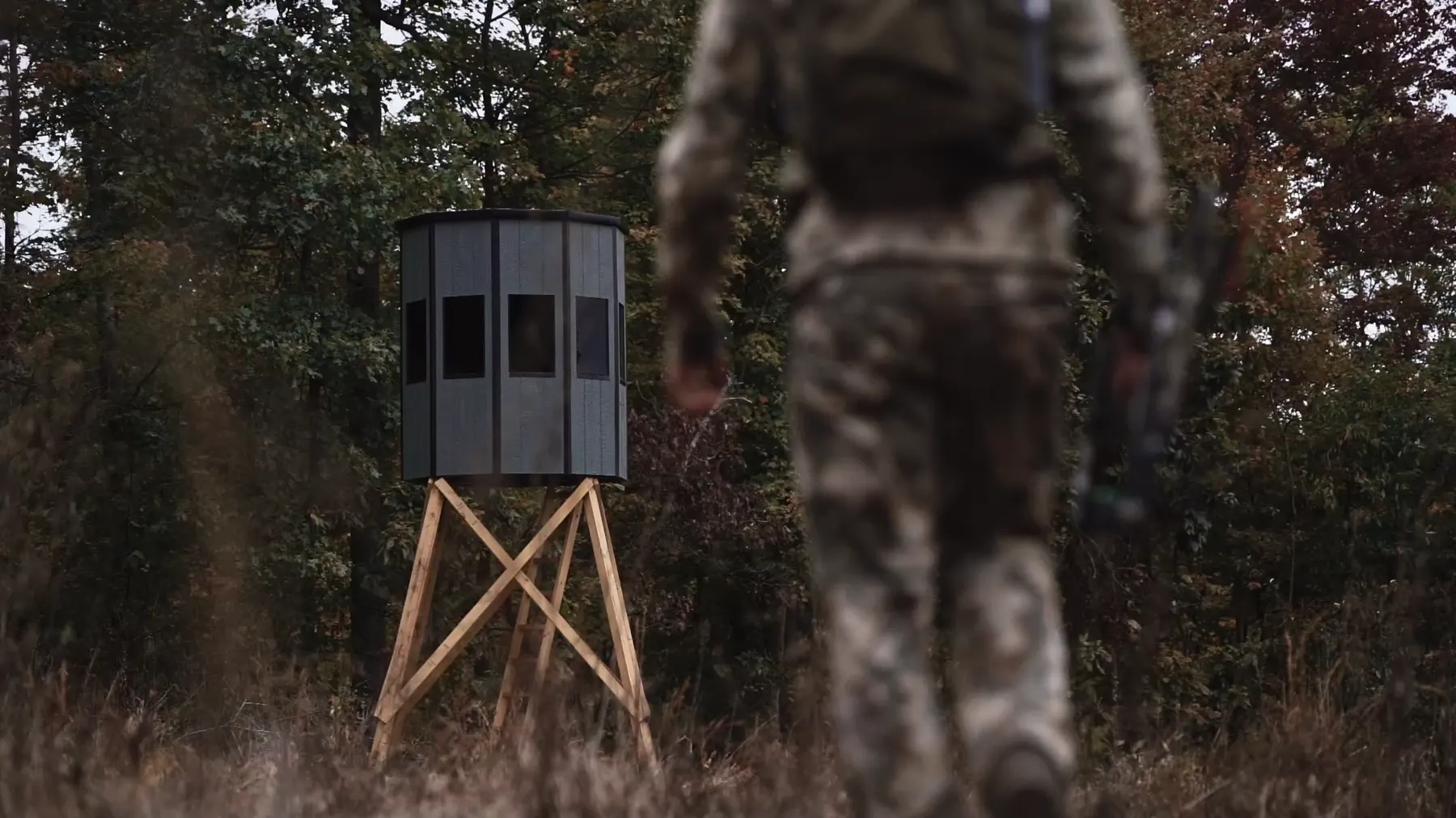 A hunter walking out to a NXTGen blind on a tower.